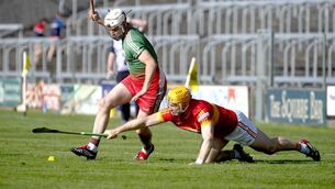 <p>Padraig Delaney (Harps) stretching to deny Dean Carey (Borris/Kilcotton) possession of the sliotar in the SHC quarter-final 	 Photo: Denis Byrne</p>