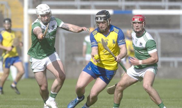 Colm Walsh (Abbeyleix) setting up a play on this sliotar as Paddy Keating and David Dooley (Rosenallis) move to block him 	Photo: Denis Byrne