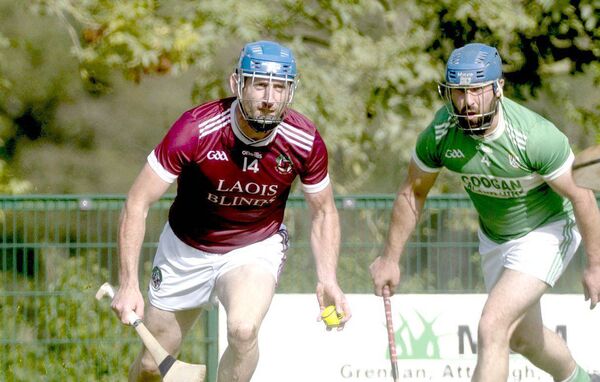 Eddie Dwyer (Ballinakill) in possession with Sean O'Neill (Ballyfin) moving in to challenge Photo: Denis Byrne Eddie Dwyer (Ballinakill) in possession with Sean O'Neill (Ballyfin) moving in to challenge Photo: Denis Byrne