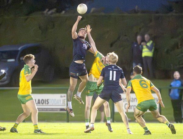 Aaron Dorgan (Graiguecullen) gets up highest to fist this ball down against Park/Ratheniska Photo: Denis Byrne Aaron Dorgan (Graiguecullen) gets up highest to fist this ball down against Park/Ratheniska Photo: Denis Byrne