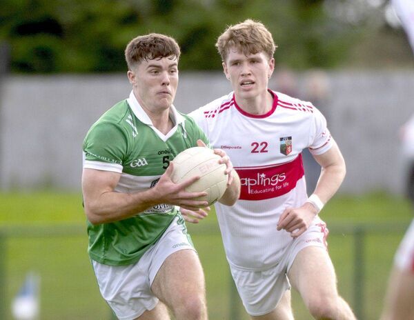 David Dooley (Rosenallis) in possession with Eoin Montague (Emo) staying close 	 Photo: Denis Byrne