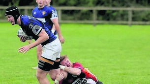 <p class="contextmenu internal_Caption">Portlaoise’s Ronan Donlon looks to break out of this tackle 	Photo: David Maher</p>