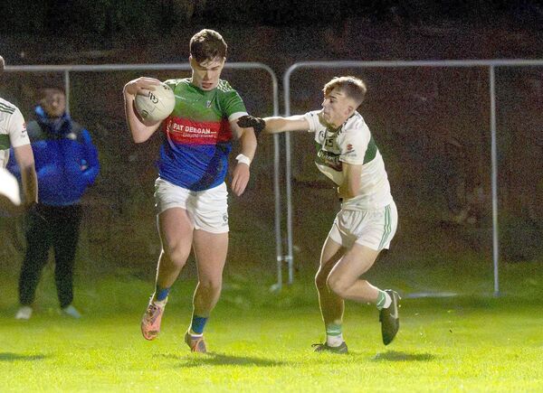 Eoghan Deegan (SPG) in possession with David Timmons (Portlaoise) moving to challenge Photo: Denis Byrne Eoghan Deegan (SPG) in possession with David Timmons (Portlaoise) moving to challenge Photo: Denis Byrne